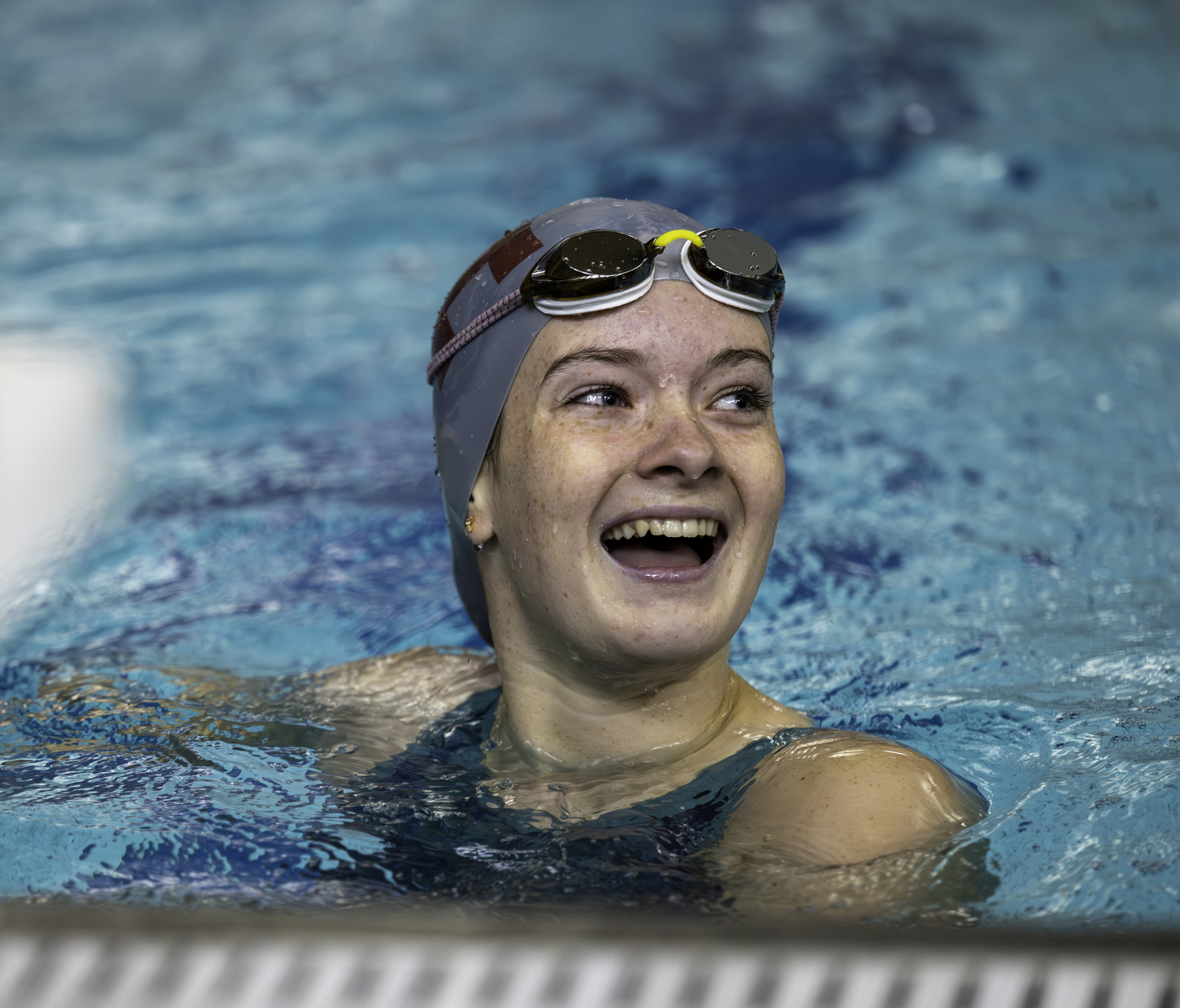 Sydney Powers reacts to her 100-yard freestyle time.  MARIANNE BARNETT
