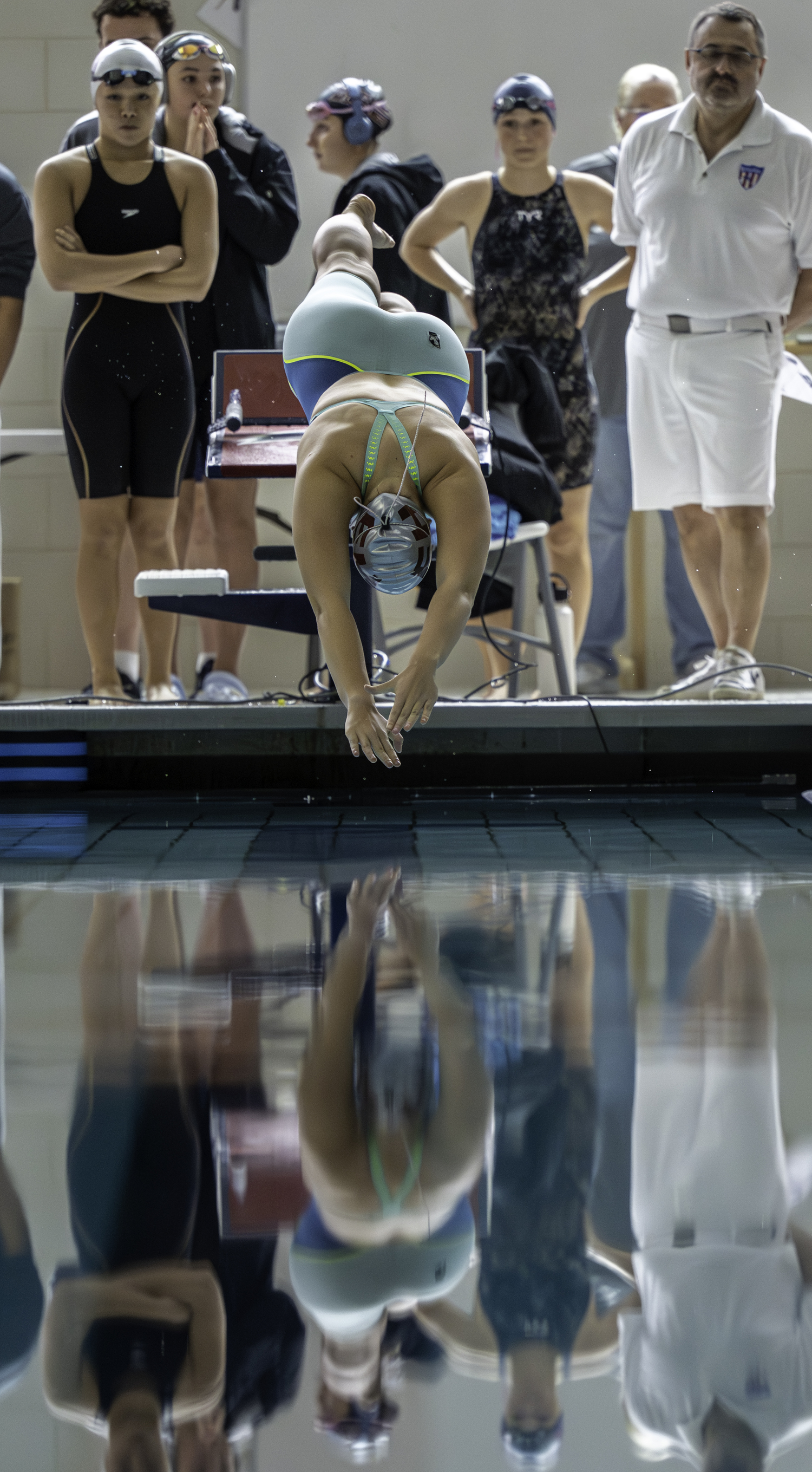 Lizzy Daniels dives headfirst into the pool for the 100-yard butterfly.  MARIANNE BARNETT