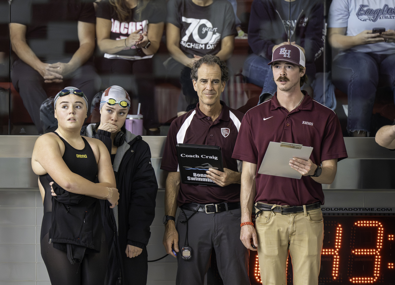 Ginger Griffin, left, Vanessa Rizzo and the coaches Craig and Thomas Brierley check out the scoreboard.  MARIANNE BARNETT