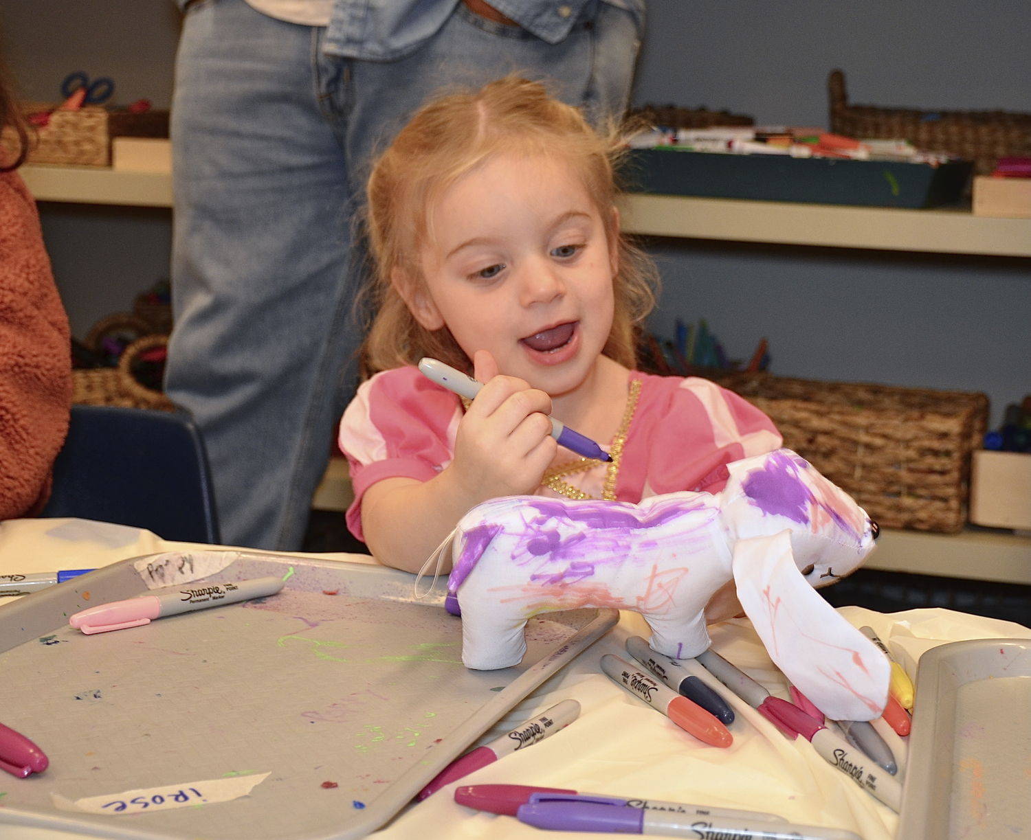 Rosie Spitzli decorates a stuffed dog at the ARF (Animal Rescue Fund) Hamptons community event at the Shine Studio in Bridgehampton on Sunday afternoon.  KYRIL BROMLEY