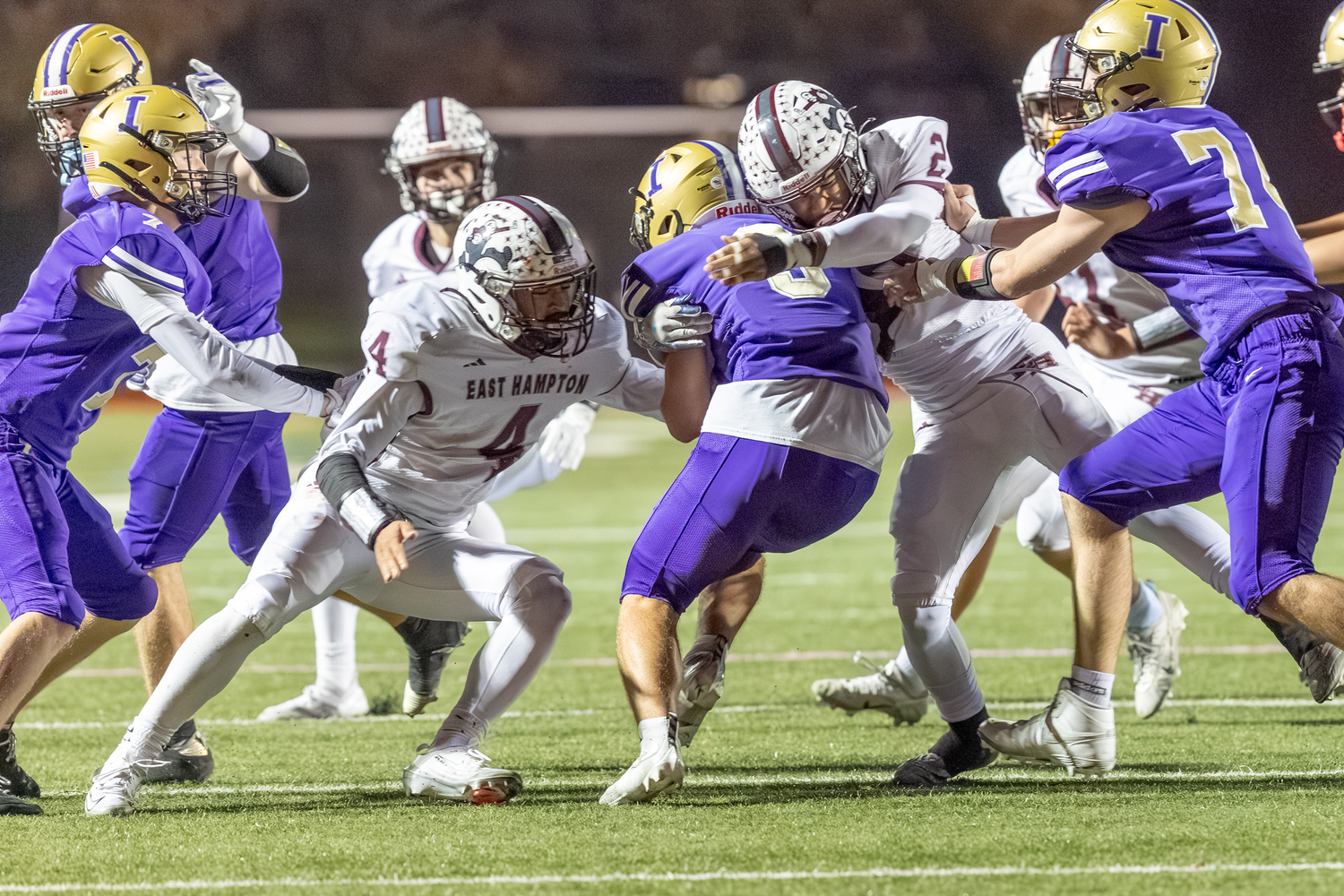 Bridgehampton's Alex Davis (4) and Jai Feaster (2) converge on Islip quarterback Jack Rao.  RON ESPOSITO