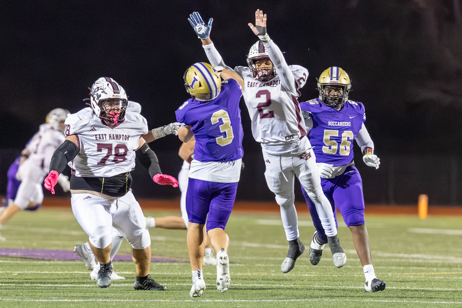 Jai Feaster (2) and Dylan Ward (78) rush Islip quarterback Jack Rao.  RON ESPOSITO