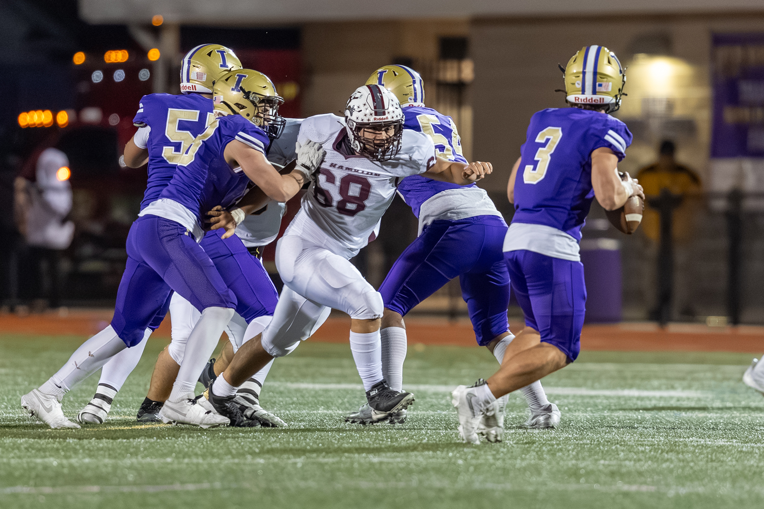 East Hampton sophomore Orson O'Brien has his sights set on Islip quarterback Jack Rao as he breaks through the offensive line.  RON ESPOSITO