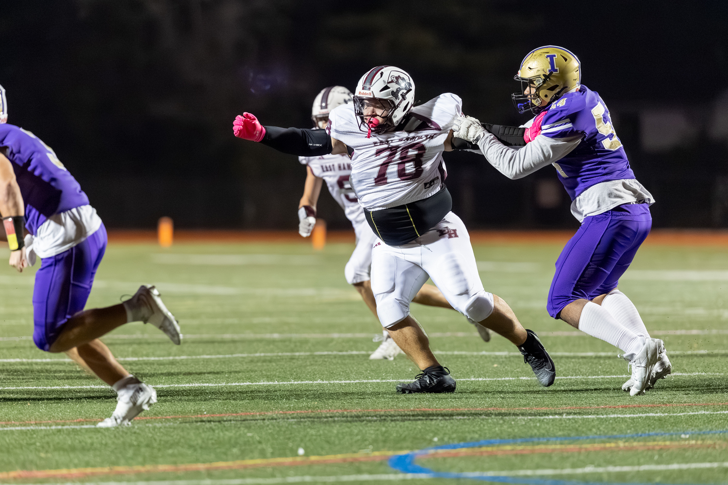 An Islip offensive lineman gets a little too much of East Hampton senior Dylan Ward's jersey.  RON ESPOSITO