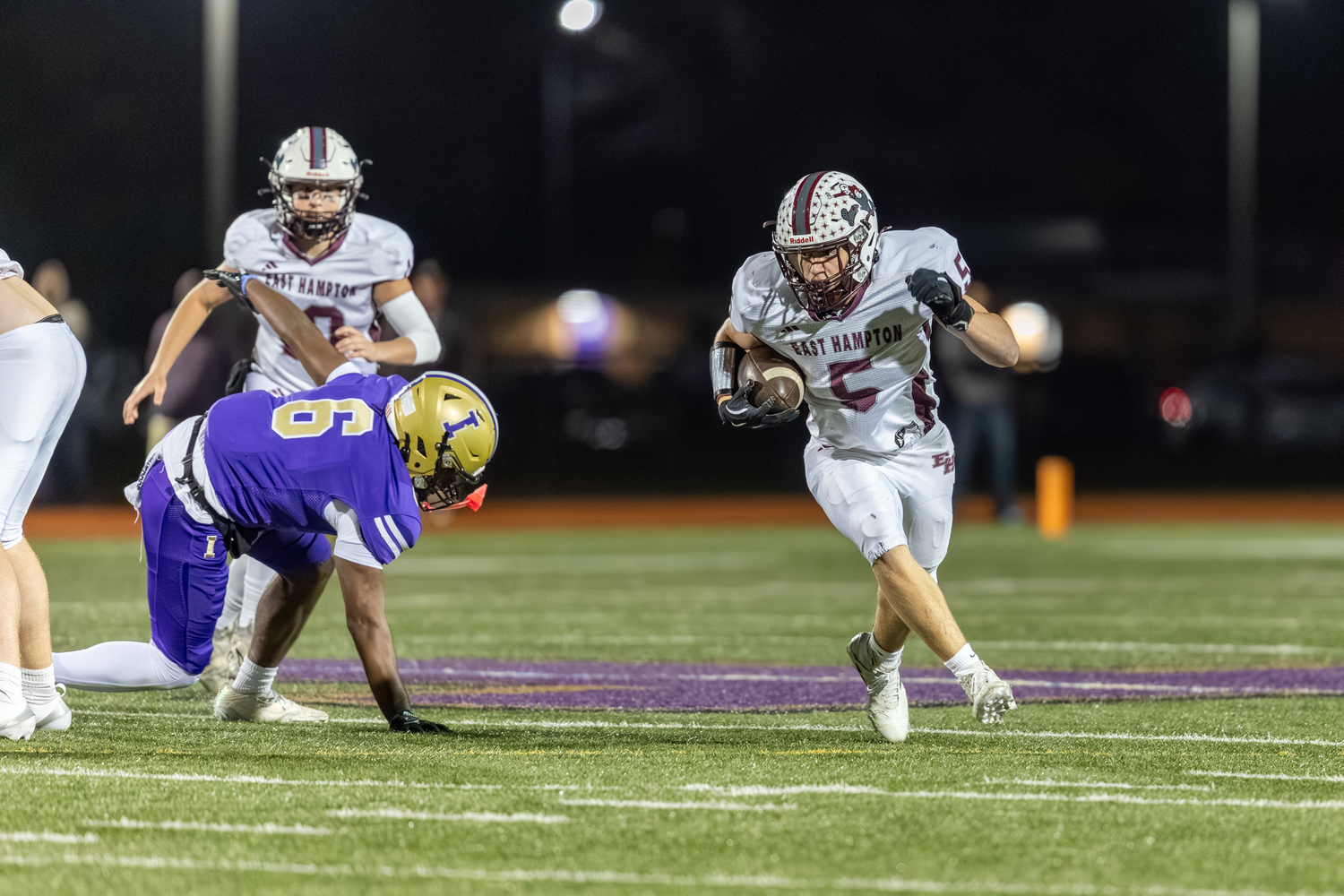 East Hampton junior Jackson Ronick takes advantage of an Islip defender going down to gain some yards.  RON ESPOSITO