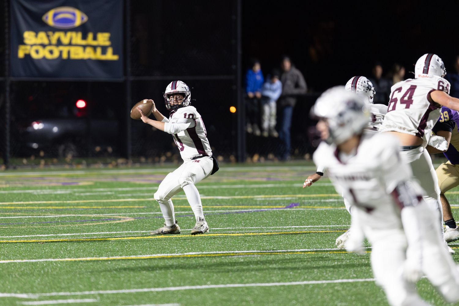 East Hampton senior quarterback Theo Ball rears back to pass.  RON ESPOSITO