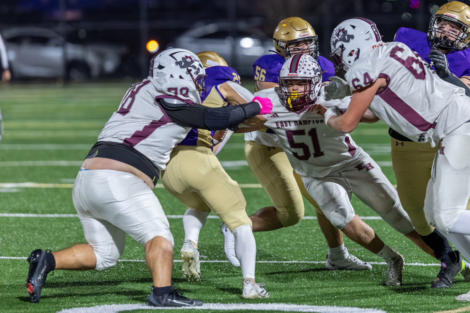 Dylan Ward (78) and James Corwin (51) wrap up Sayville running back Tristan Vitale.  RON ESPOSITO