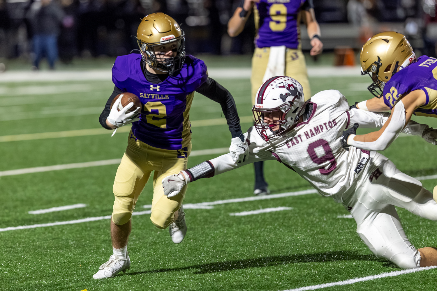 Charlie Stern tries to get to Sayville's Timmy Holahan while being blocked by Tristan Vitale.  RON ESPOSITO