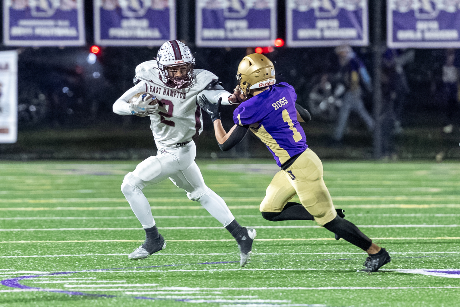 Bridgehampton senior Jai Feaster stiff arms Sayville's Robert Hoss.  RON ESPOSITO