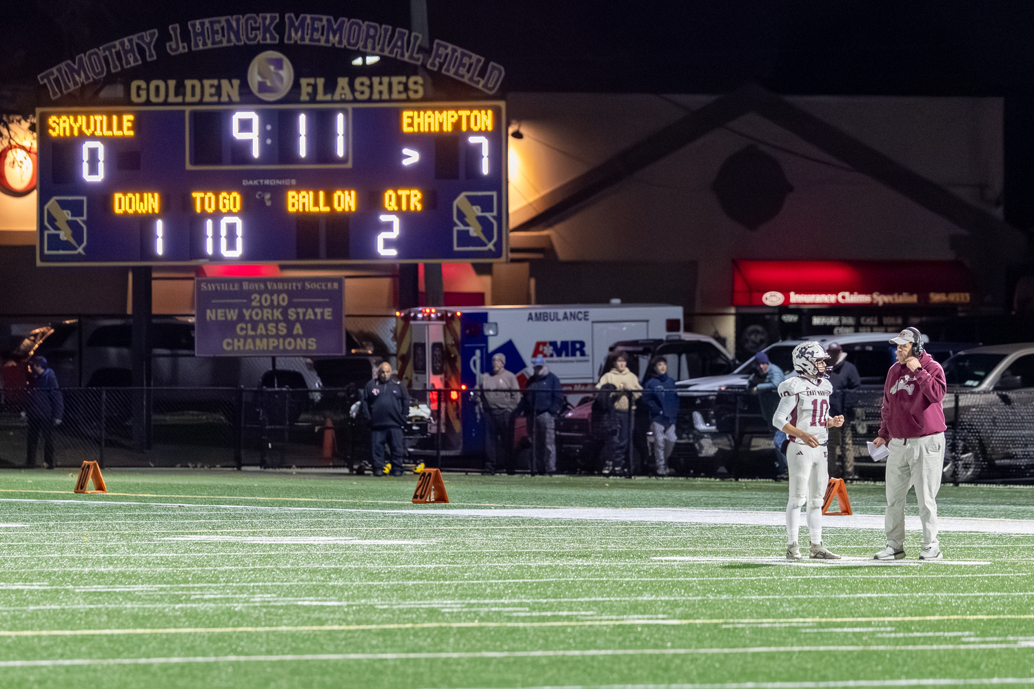 East Hampton head coach Joe McKee gets a play to his quarterback Theo Ball early on in Friday night's game.  RON ESPOSITO