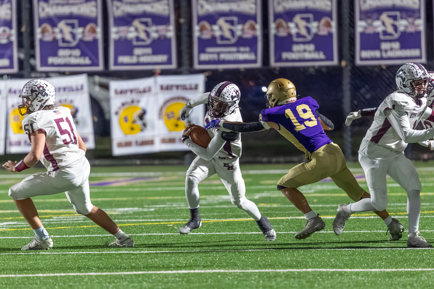 Bridgehampton senior Jai Feaster tries to avoid a Sayville defender miss on a kickoff.  RON ESPOSITO