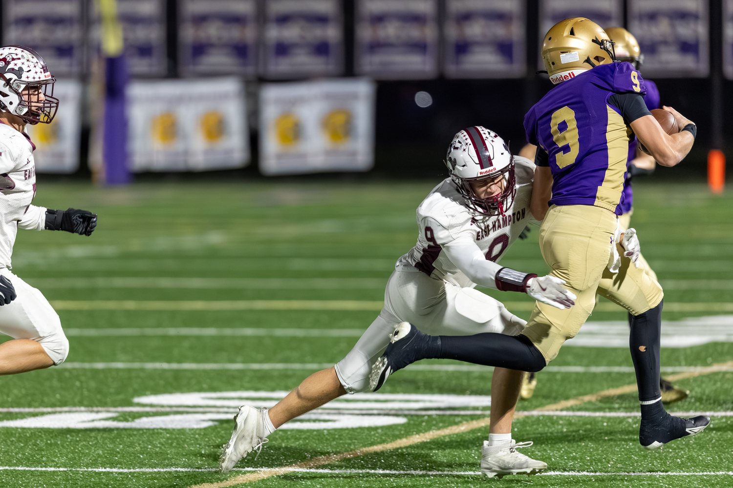 East Hampton senior Charlie Stern tries to wrap up Sayville quarterback Patrick Coan. RON ESPOSITO