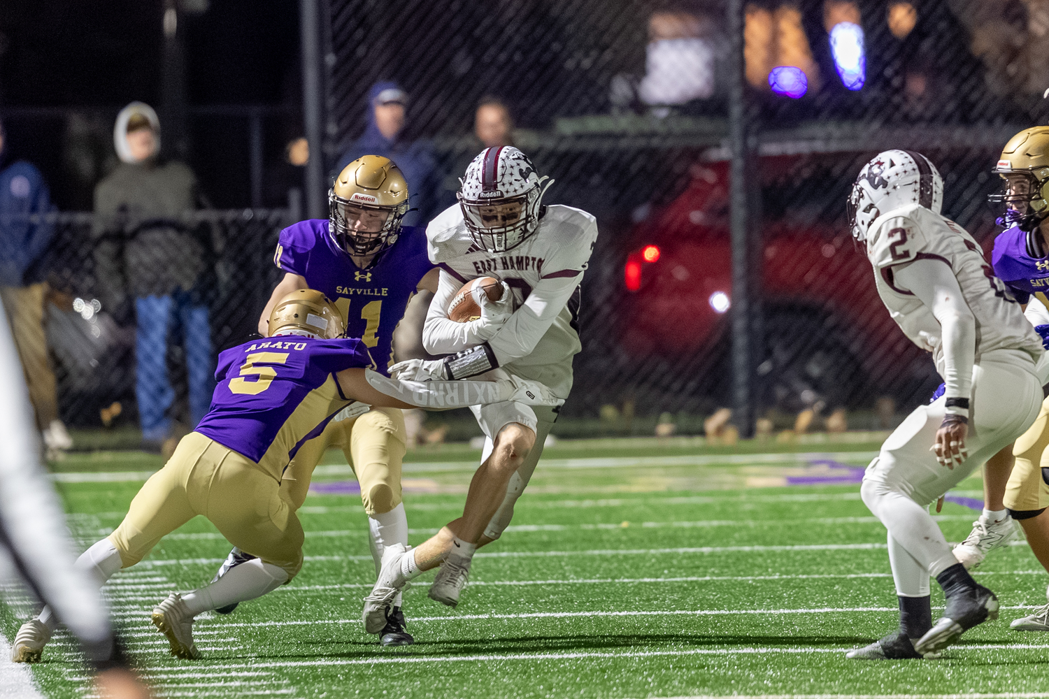 East Hampton senior Livs Kuplins breaks out of the grasp of Sayville's Jake Arato.  RON ESPOSITO