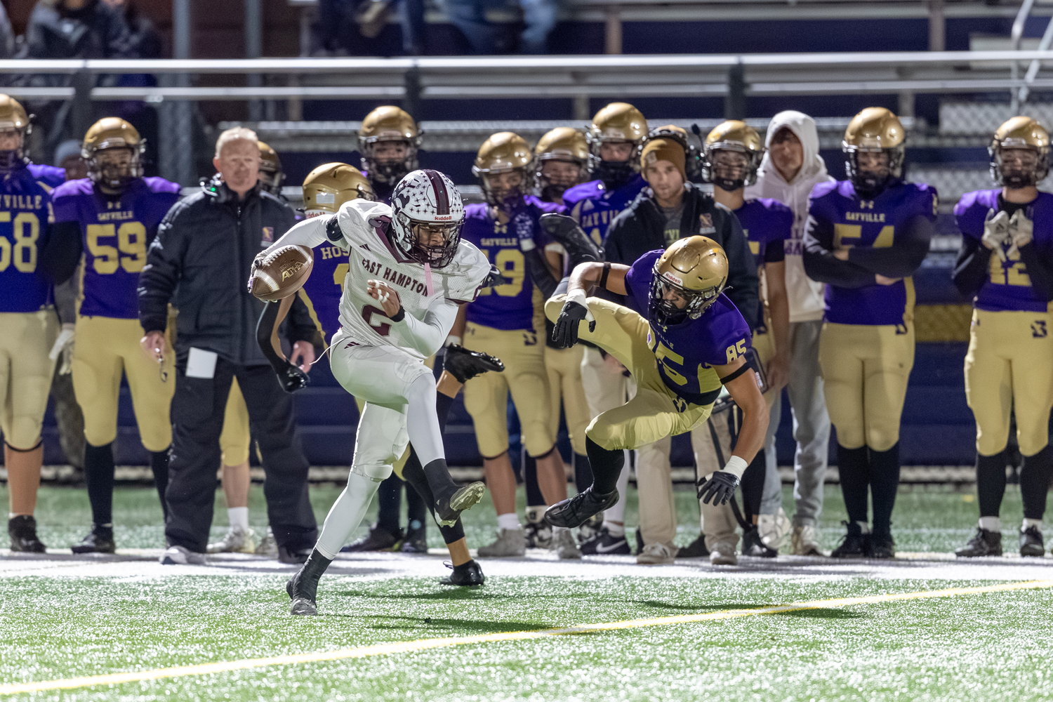 Bridgehampton senior Jai Feaster makes Sayville's Saad Abid miss en route to his 81-yard touchdown in the first quarter.  RON ESPOSITO
