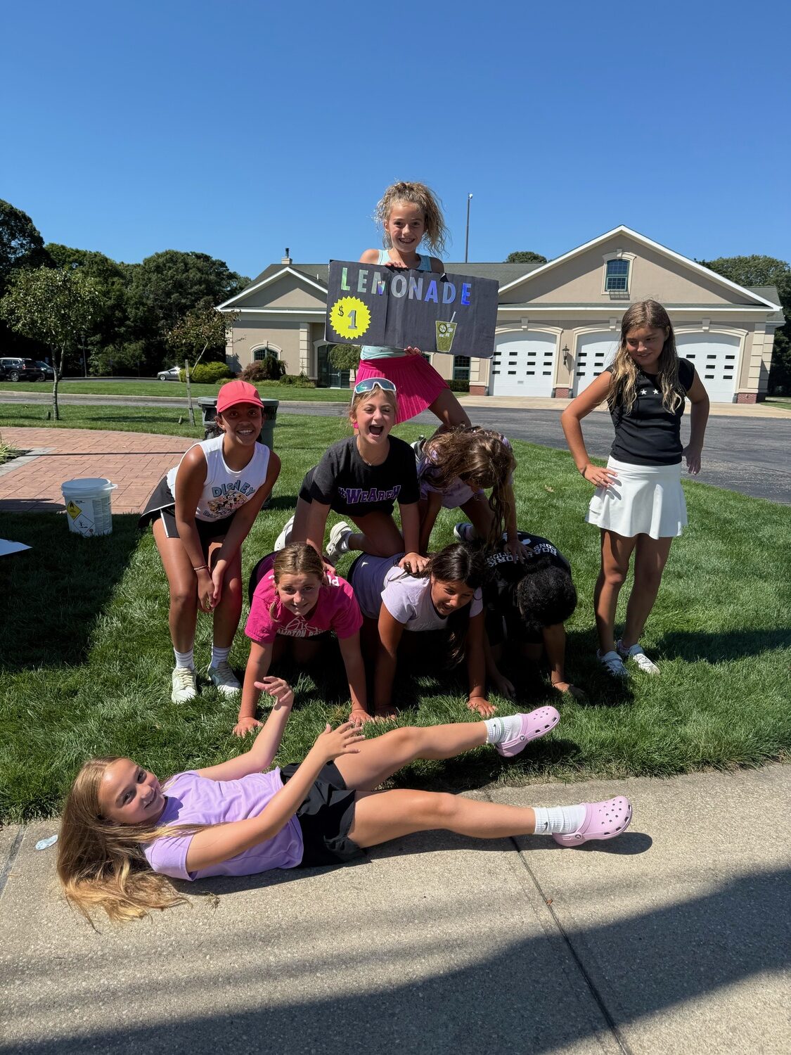 The girls had fun setting up a lemonade stand this past summer where they raised over $1,400 for brand new uniforms and future items.  COURTESY ANTHONY SIDERATOS