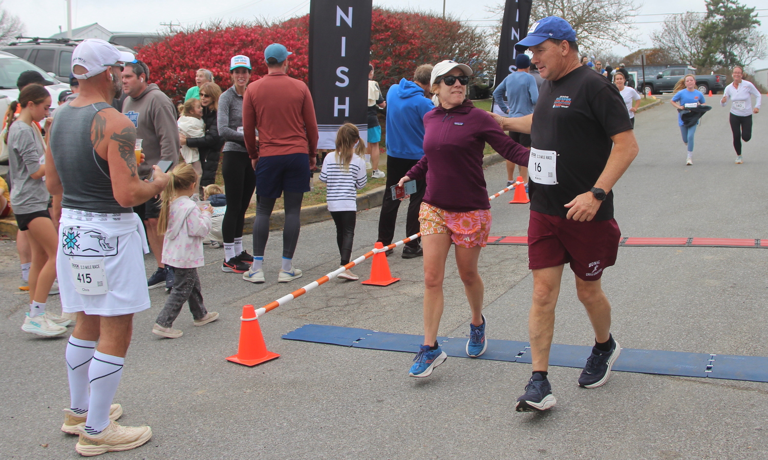 Kevin Barry and his wife Cheryl Cashin cross the finish line of Montauk's dock race on Sunday.  JACK GRAVES