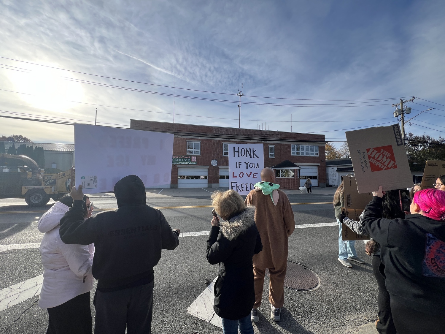 Protesters lined Montauk Highway in Hampton Bays on Friday morning voicing their objections to immigration raids that ensnared several people in the community and in Westhampton and Riverhead earlier in the week. DANA SHAW