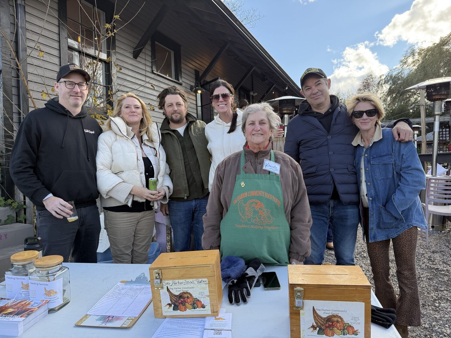Kidd Squid Brewing Company hosted a community food drive and fundraiser to support the Sag Harbor and Springs Food Pantries on Sunday afternoon. In attendance were the event organizers, from left to right, Rory McEvoy, Grainne Coen, Fitzhugh Karol, Brooke Bohnsack, Louise Driscoll from the Sag Harbor Food Pantry, Shawn Sachs and Lyndsay Caleo Karol. GAVIN MENU