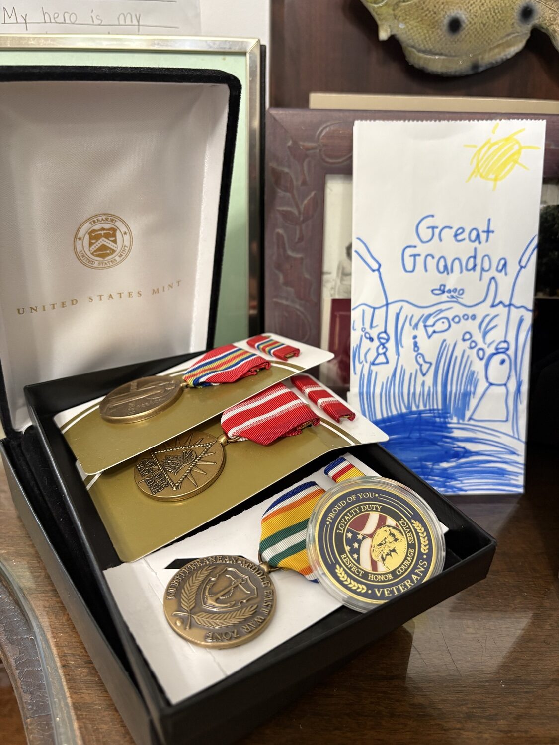 Mementos from John Siebold's time spent serving in the Merchant Marines in World War II share prominent space in his home alongside artwork from his great-grandchildren. CAILIN RILEY