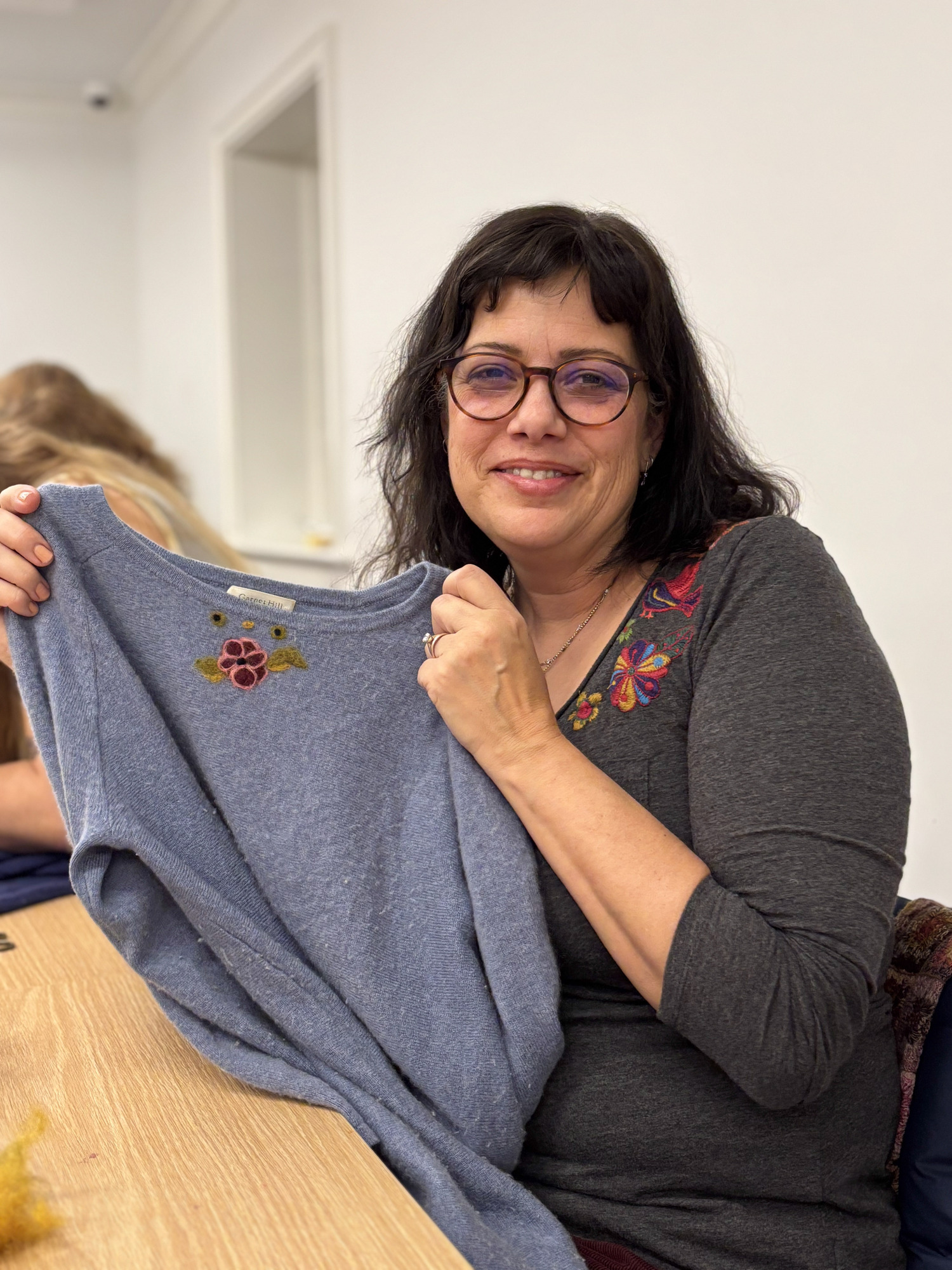 Erica-Lynn Huberty, herself a pioneer in the fiber arts world, shows off her creation at Lambrecht's sweater felting workshop. Photo courtesy of Guild Hall.