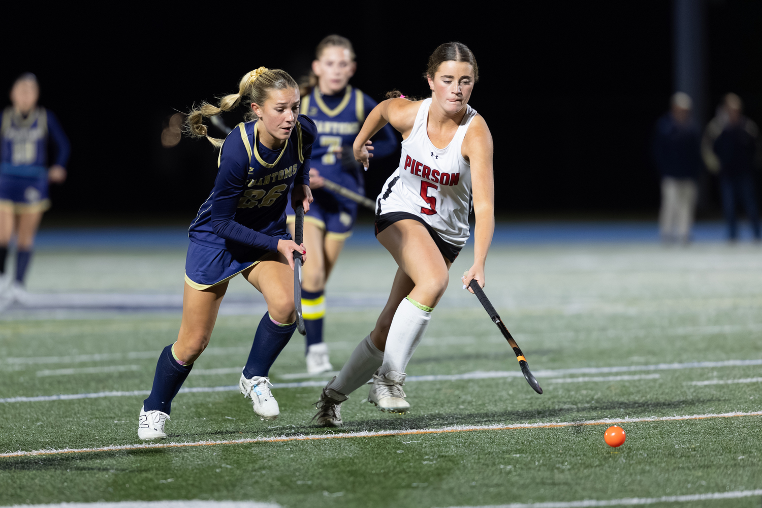 Pierson's Lochlyn Craig and Bayport's Olivia Farrell race after the ball during Tuesday night's county championship at Rocky Point High School.  RON ESPOSITO