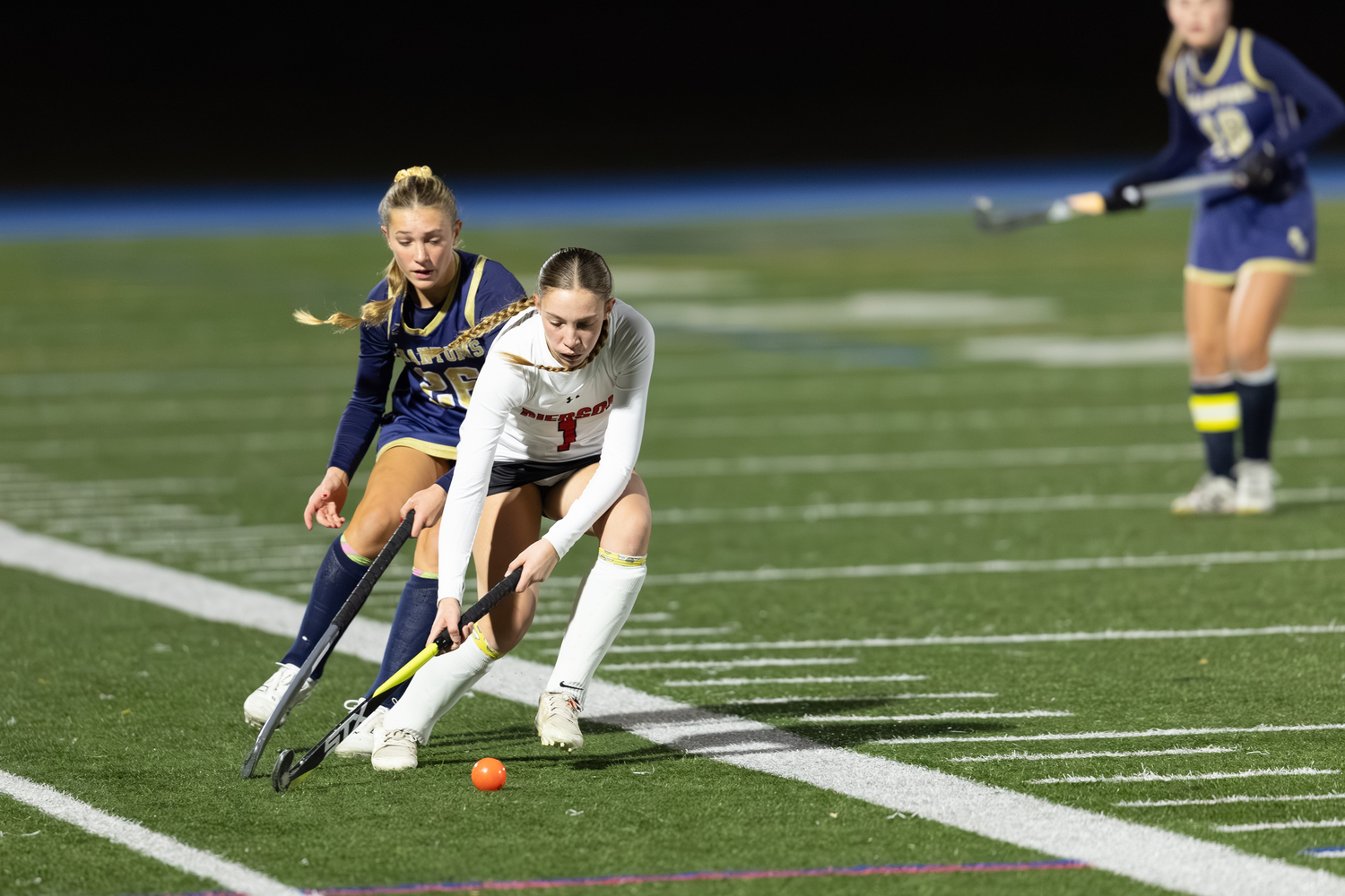 Bridgehampton's Kate Vinski plays the ball with Bayport's Olivia Farrell covering her.  RON ESPOSITO