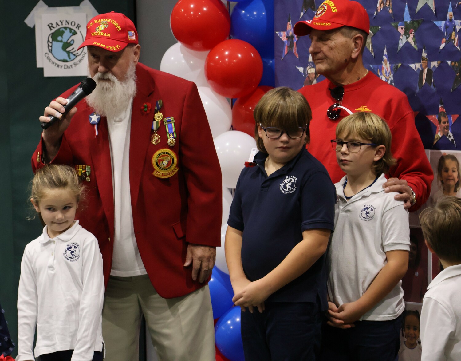 Raynor Country Day School hosted its annual Veterans Day ceremony last week with more than 60 veterans in attendance.  Under the direction of instrumental teacher Leanna Bartley, the Senior Band performed The Star Spangled Banner and This Is My Country.  Choral teacher, Suzanne Lewis, led the Pee Wee Chorus in a performance of America the Beautiful, as well as schoolwide choral performances of The Armed Forces Medley and We Give Thanks.  Student representatives demonstrated their appreciation by sharing reflective writing pieces to the veterans, which included second-grader Gigi Guerra, third-grader Roman Rogers, fifth-graders Lily Ramsammy, Sophia Maharlouei, and James Burkly, and sixth-grader Siena Babinsky.  In addition, sixth-grader Mo Buffa, performed Taps, while his classmates presented a wreath of honor during a moment of silence.
At the event, sixth-graders Porter Faulk and Levi Beaver presented a donation to Honor Flight Long Island from a recent student-led Jeans Day fundraiser. COURTESY RAYNOR COUNTRY DAY SCHOOL