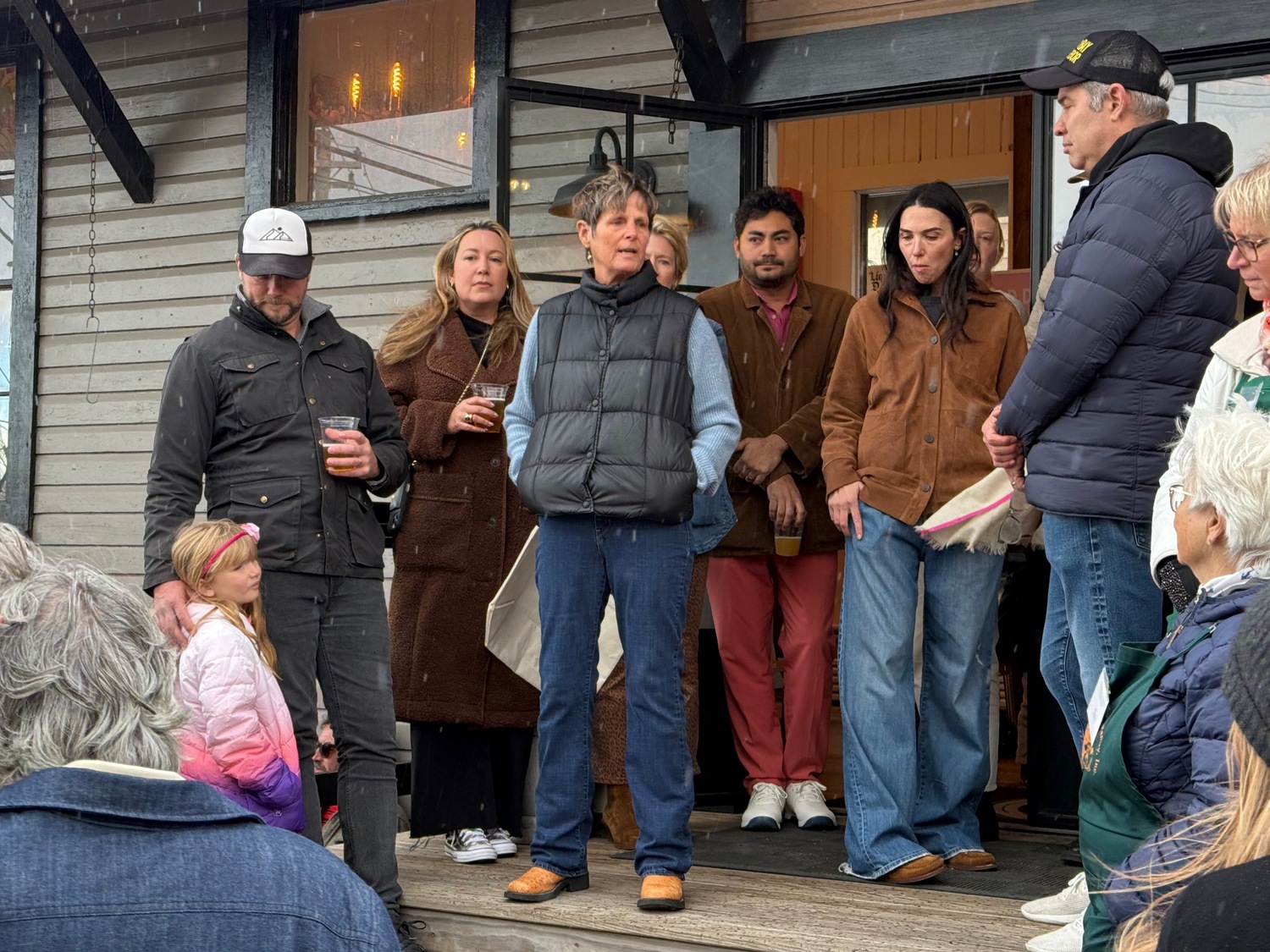 A large crowd gathered at Kidd Squid Brewery on Sunday for a community food drive and fundraiser supporting the Sag Harbor and Springs Food Pantries, both of which are confronting record demand amid rising food costs and reduced assistance programs.
Organized by Shawn Sachs and Laney Crowell, and a team of local volunteers including Kidd Squid Brewery, the event drew steady donations throughout the afternoon, with families dropping off food and household items beginning at. noon. A community moment at 2 p.m. brought attendees together in support of the two pantries’ work, and featured speeches by Sachs, Sag Harbor Food Pantry Executive Director Evelyn Ramunno and Springs Food Pantry Director Holly Reichart-Wheaton, as well as incoming Sag Harbor Food Pantry Executive Director Terrie Diat, who will replace Ramunno at the helm of that organization in the new year.  Early fundraising pushed the effort past the halfway mark of its $30,000 goal before the event even began, and contributions continued on site.
Organizers said they were grateful for the strong turnout and ongoing support from residents who couldn’t attend but donated online.