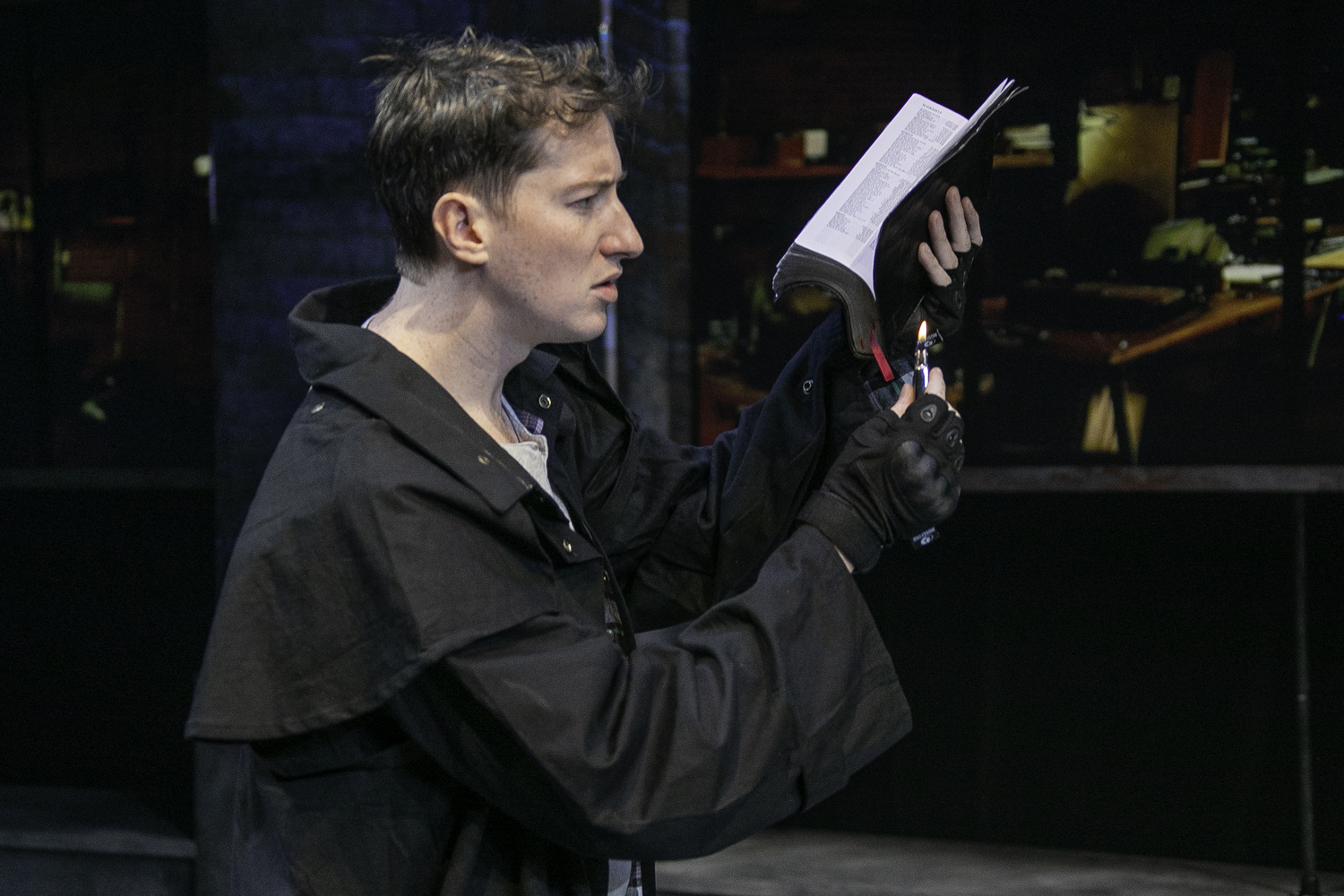 Montag (John Kroft) prepares to burn a book in Bay Street Theater's production of 