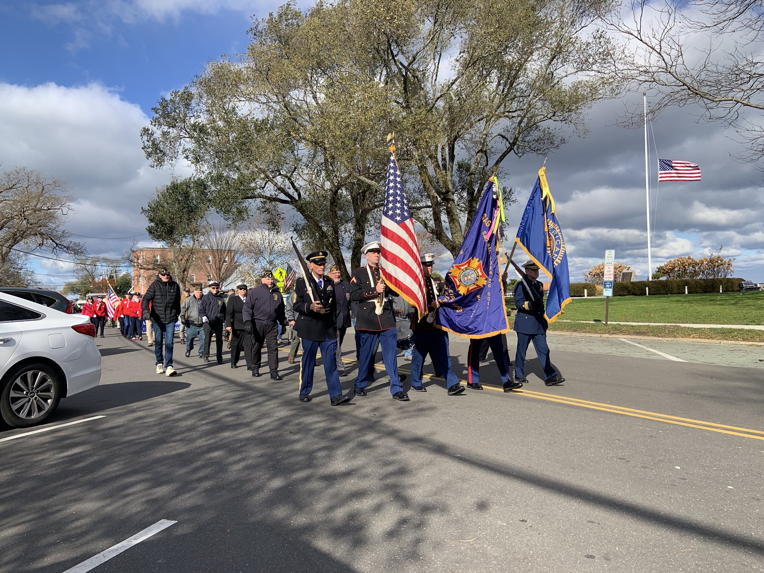 A color guard led the Sag Harbor Veterans Day parade down Bay Street past the flag in Marine Park that was at half-staff to honor the late Vice President Dick Cheney. STEPHEN J. KOTZ