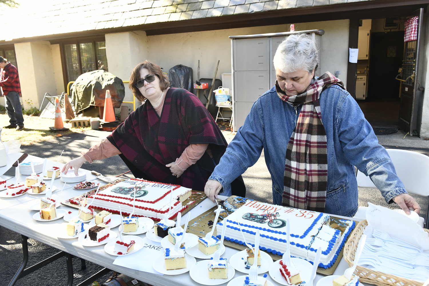 Nancy Hilbert and Jennie Steward hand out cake at the 35th ABATE (American Bikers Aimed Toward Education)  annual Food and Toy Run to  St. Mary's Episcopal Church in Hampton Bays on Sunday  This is the 35th year for this event.  Over 170 bikers gathered  at the Elks Lodge in Riverhead proceeded to the church at bringing with them toys, non-perishable foods and other donations. St. Mary's, then disburses the items to local charitable organizations including Angel Tree Program of the Prison's Fellowship Ministry, The Retreat, children and families living on the Shinnecock Indian Reservation and local families in Hampton Bays.  DANA SHAW