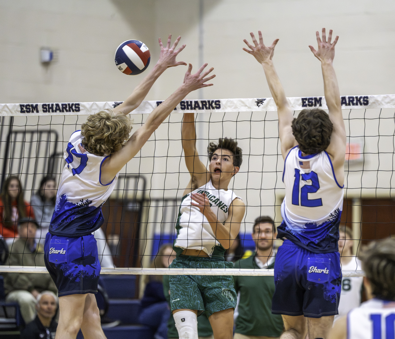 Junior outside hitter Gabe Monserrate sends the ball past Eastport-South Manor blockers in the second set. MARIANNE BARNETT