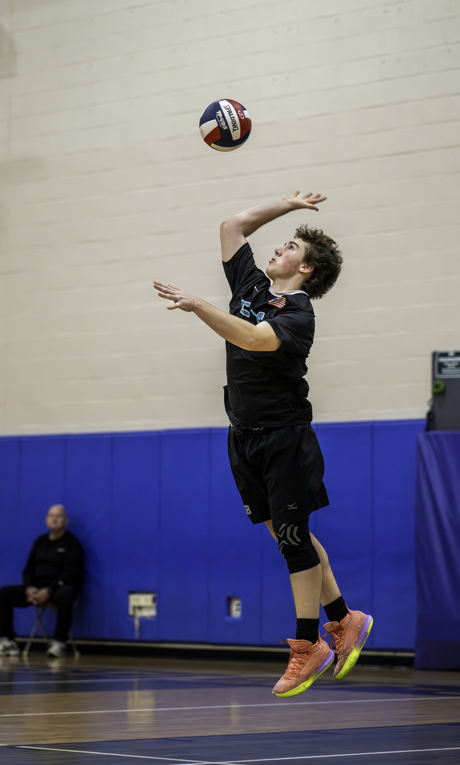 Junior libero Nolan Parsons serves. MARIANNE BARNETT