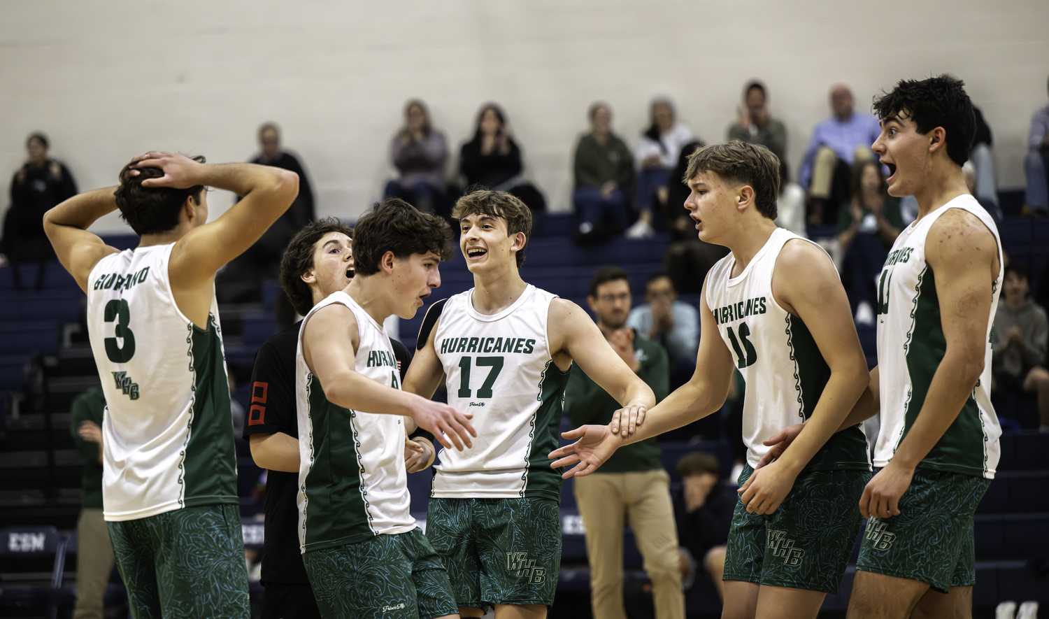 Westhampton Beach's boys volleyball team celebrates a Cameron Giordano point during the Hurricanes' comeback in the third set. MARIANNE BARNETT