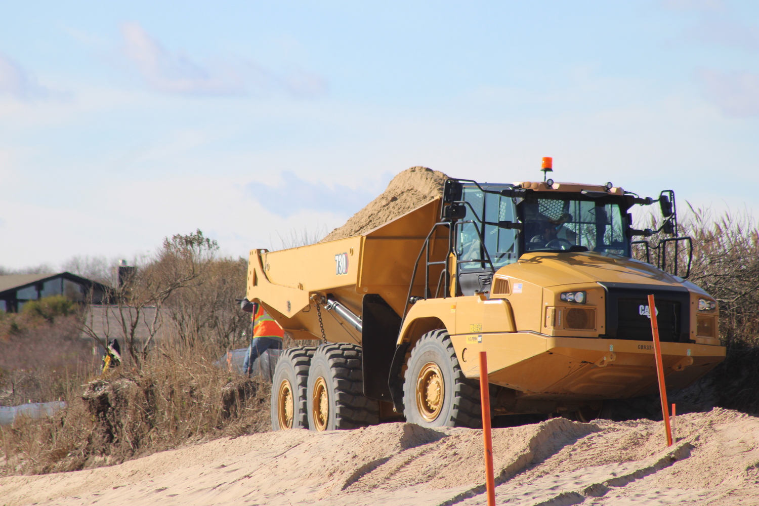 Trucks lined the beach as the Ditch Plains dune reconstruction project got underway in Montauk last week. JACK MOTZ