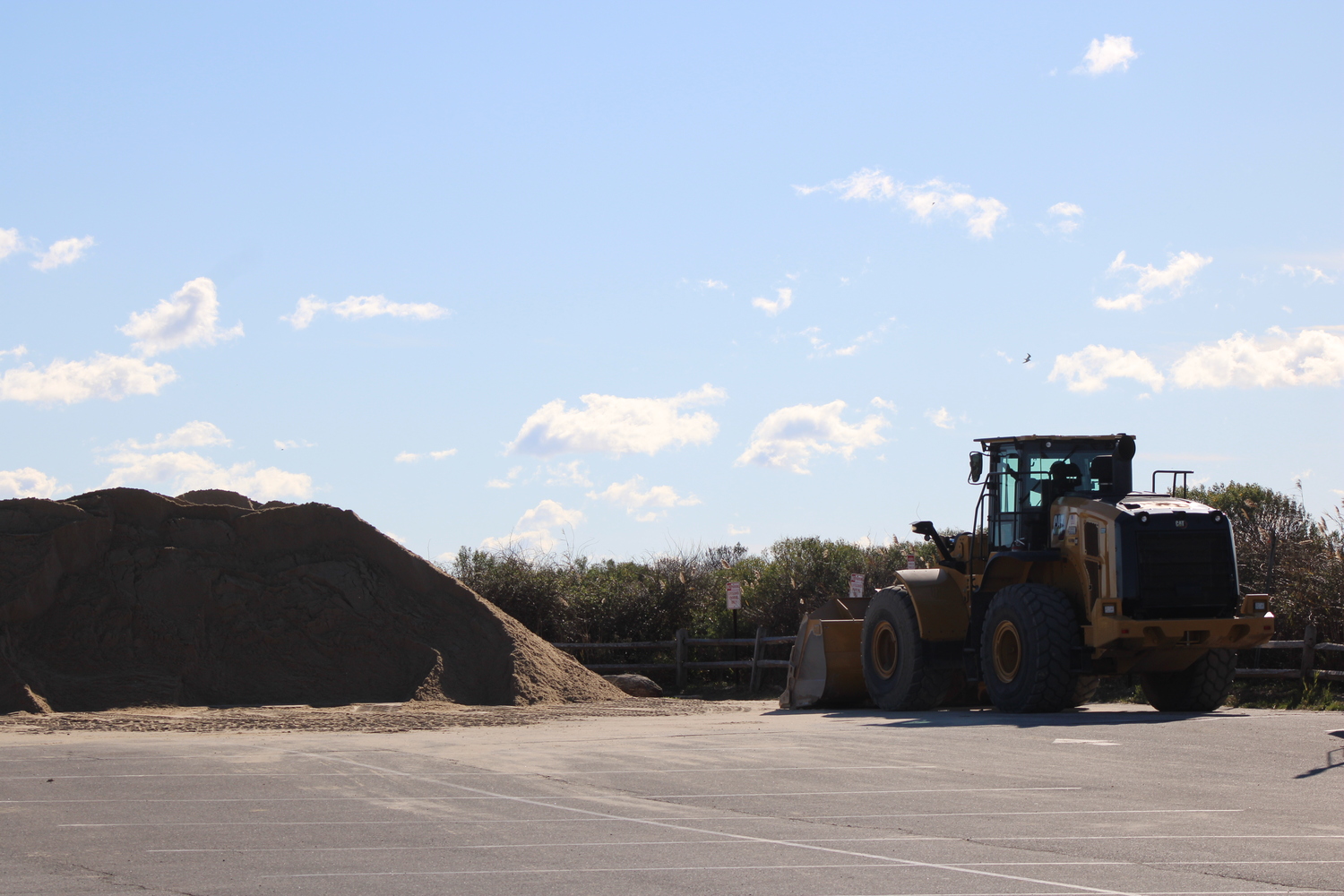 A truck, pictured, would load the piled sand into the bed of another truck, which would then bring the sand onto the beach. JACK MOTZ