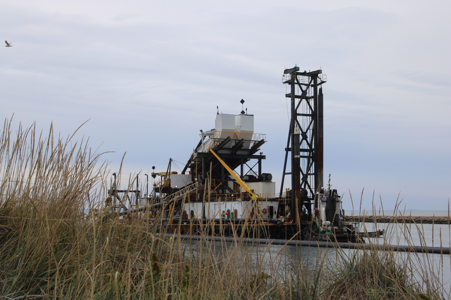 The view of Dredge Oyster Bay from near Gosman's Dock. The East Hampton Town Board stepped in to save the long-awaited operation in September, when bids came in higher than expected. The Town Board used $1.1 million from its South Fork Wind Fund to compensate for the high bids. The federal government committed $9.5 million total. JACK MOTZ