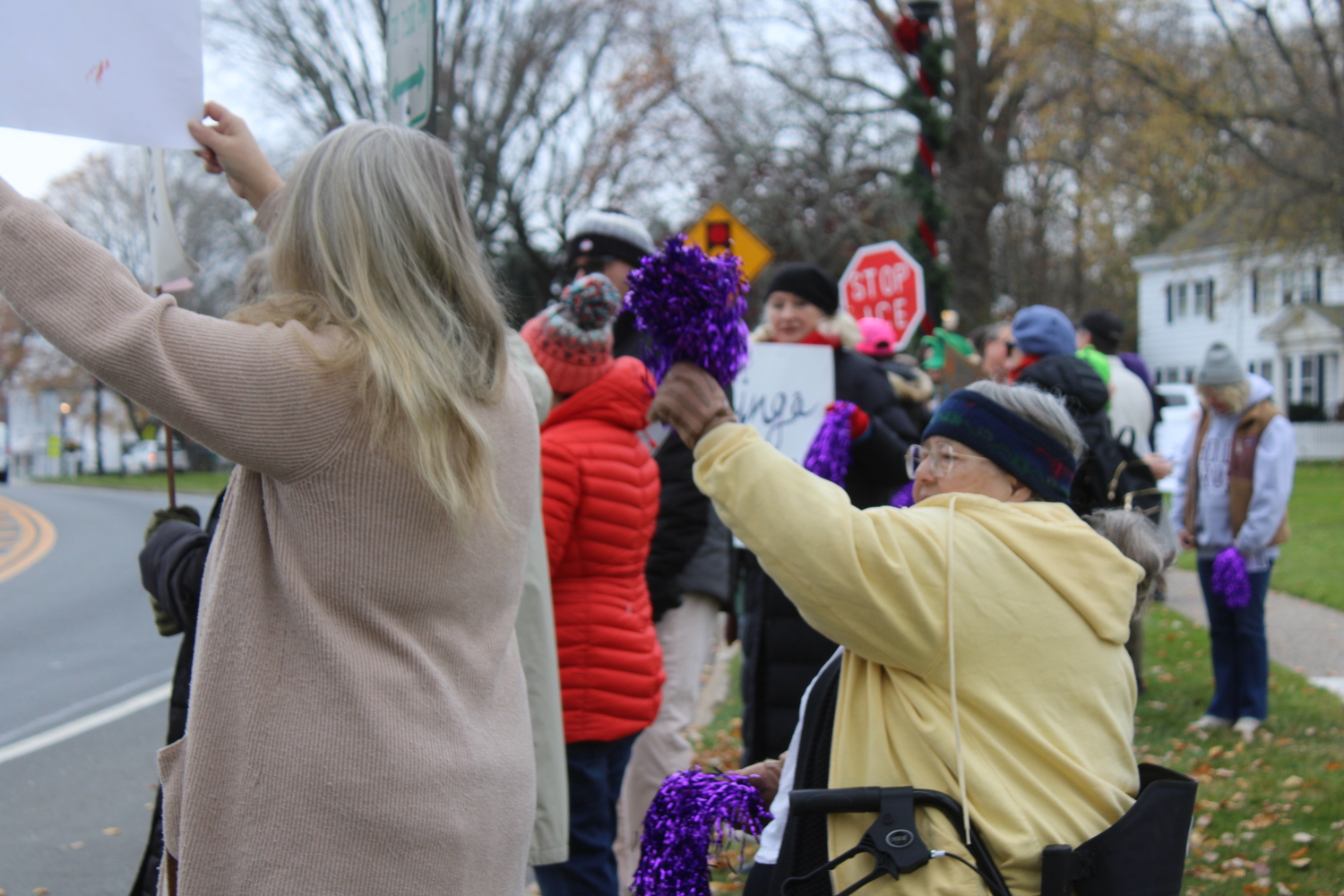Demonstrators gathered outside Hook Mill in East Hampton on Friday. JACK MOTZ