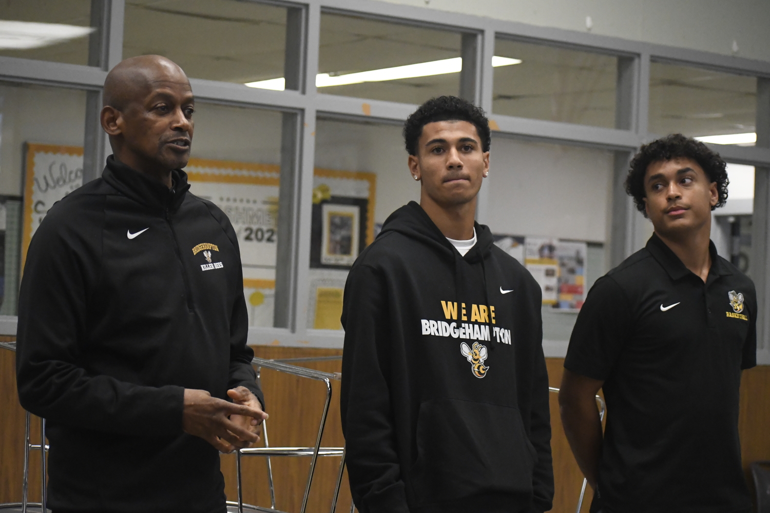 Bridgehampton head coach Carl Johnson speaks during the first-ever Suffolk Boys and Girls Basketball Coaches Association Media Day that was held at Sachem North High School on November 22 alongside his players Xavier Johnson and Alex Davis.  DREW BUDD