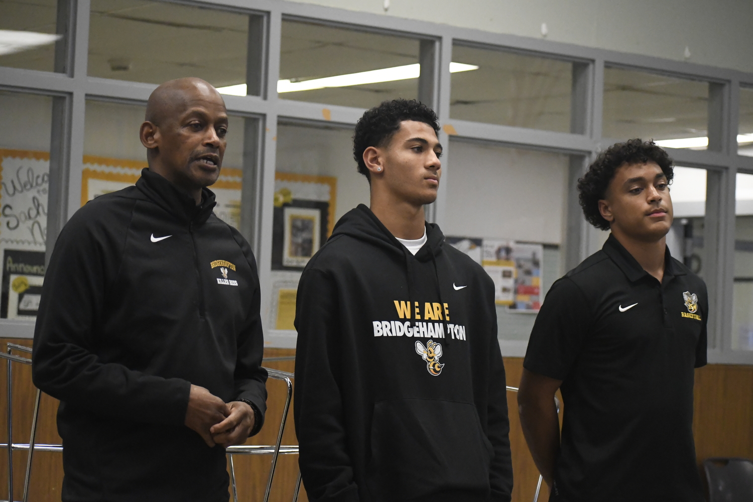 Bridgehampton head coach Carl Johnson speaks during the first-ever Suffolk Boys and Girls Basketball Coaches Association Media Day that was held at Sachem North High School on November 22 alongside his players Xavier Johnson and Alex Davis.  DREW BUDD