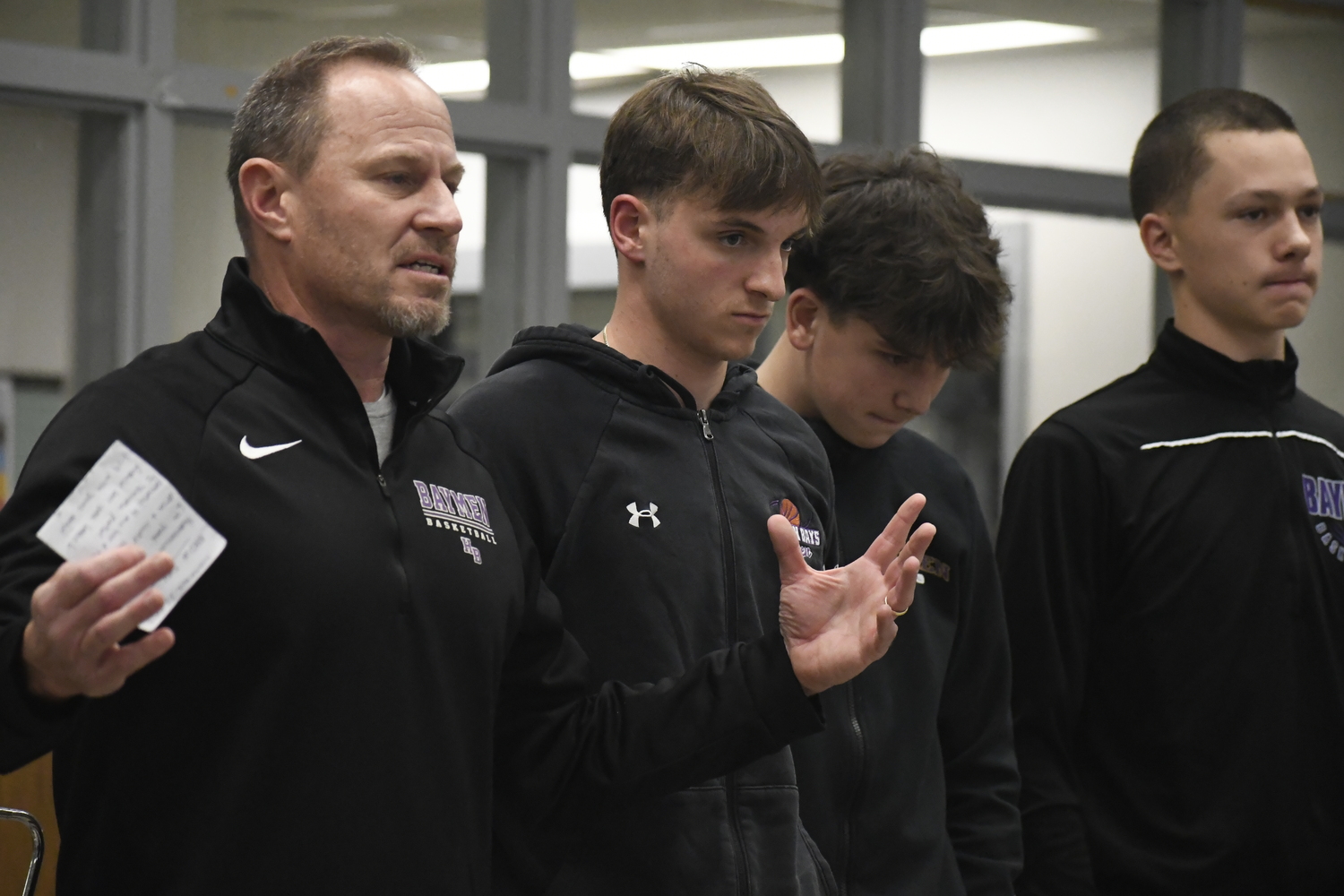 Hampton Bays head coach Noah Brown with his players Julius Lattanzio, Nate Carney and John Tedesco at the inaugural Suffolk Boys and Girls Basketball Coaches Association Media Day that was held at Sachem North High School on November 22.   DREW BUDD
