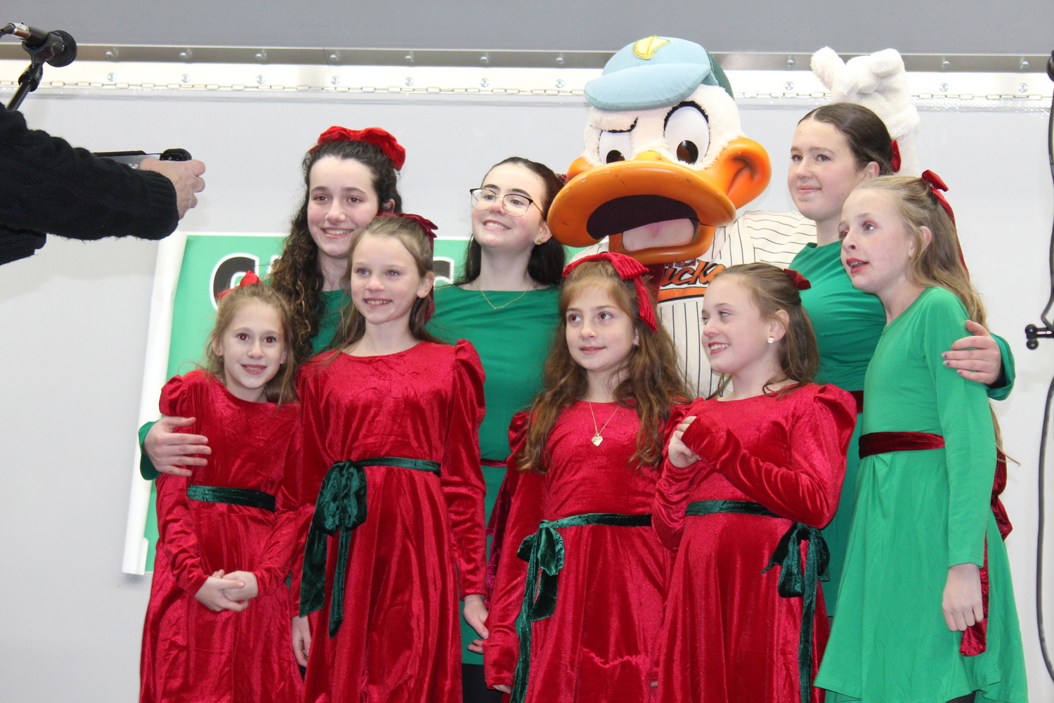 Local dance group Gaelic Groove poses with Long Island Ducks mascot QuackerJack ahead of the Big Duck lighting. LEE MEYER