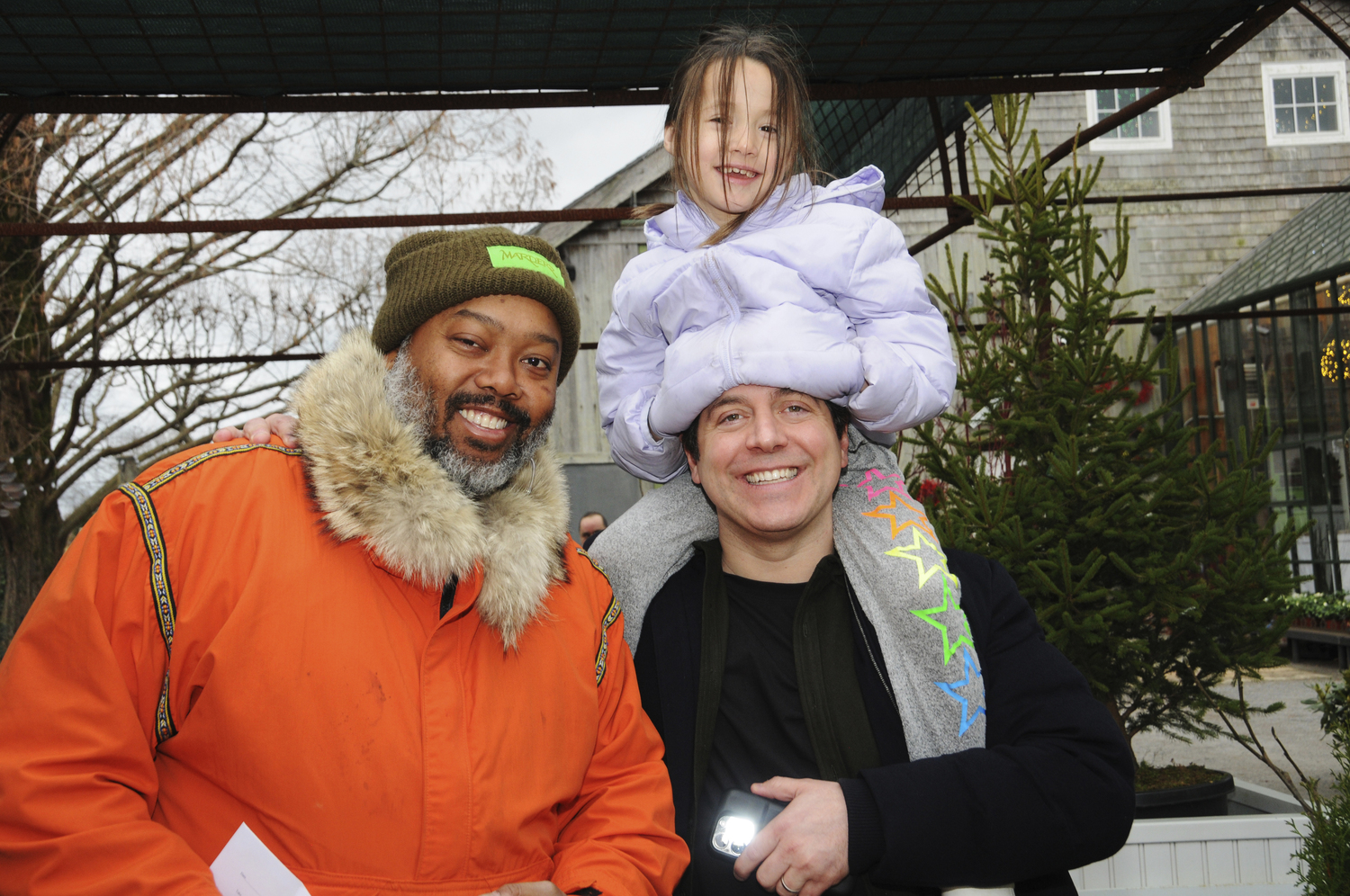 Allan Hunter, Emma Altuzarra-Weissman and Seth Weissman at the 49th annual holiday open house at Marders in Bridgehampton on Sunday. The Genesis Ensemble, managed by Deacon Kenneth R. Brown performed.  RICHARD LEWIN
