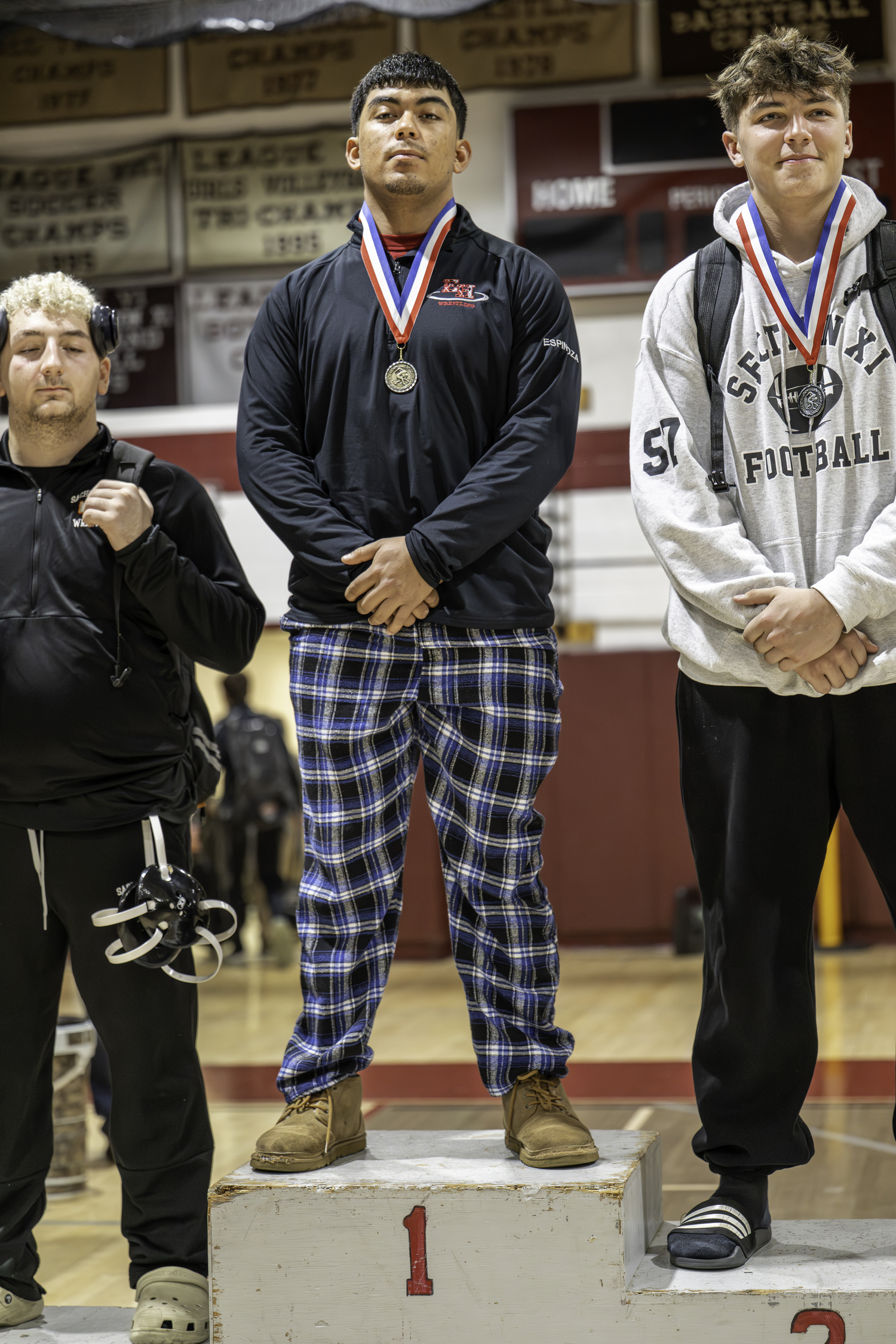 Juan Espinoza atop the podium after winning the 215-pound weight class on Saturday. MARIANNE BARNETT