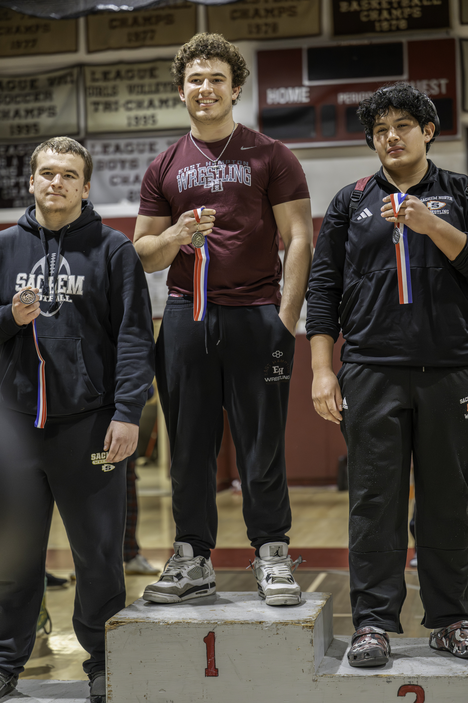 East Hampton senior Franco Palombino atop the podium after winning the 285-pound weight class at his team's annual Sprig Gardner tournament on Saturday.  MARIANNE BARNETT