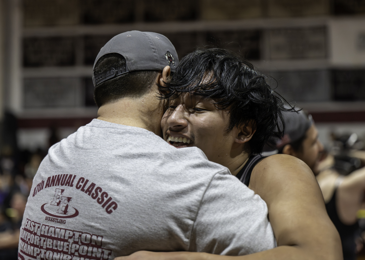 Brian Torres hugs head coach Ethan Mitchell after a victory.  MARIANNE BARNETT