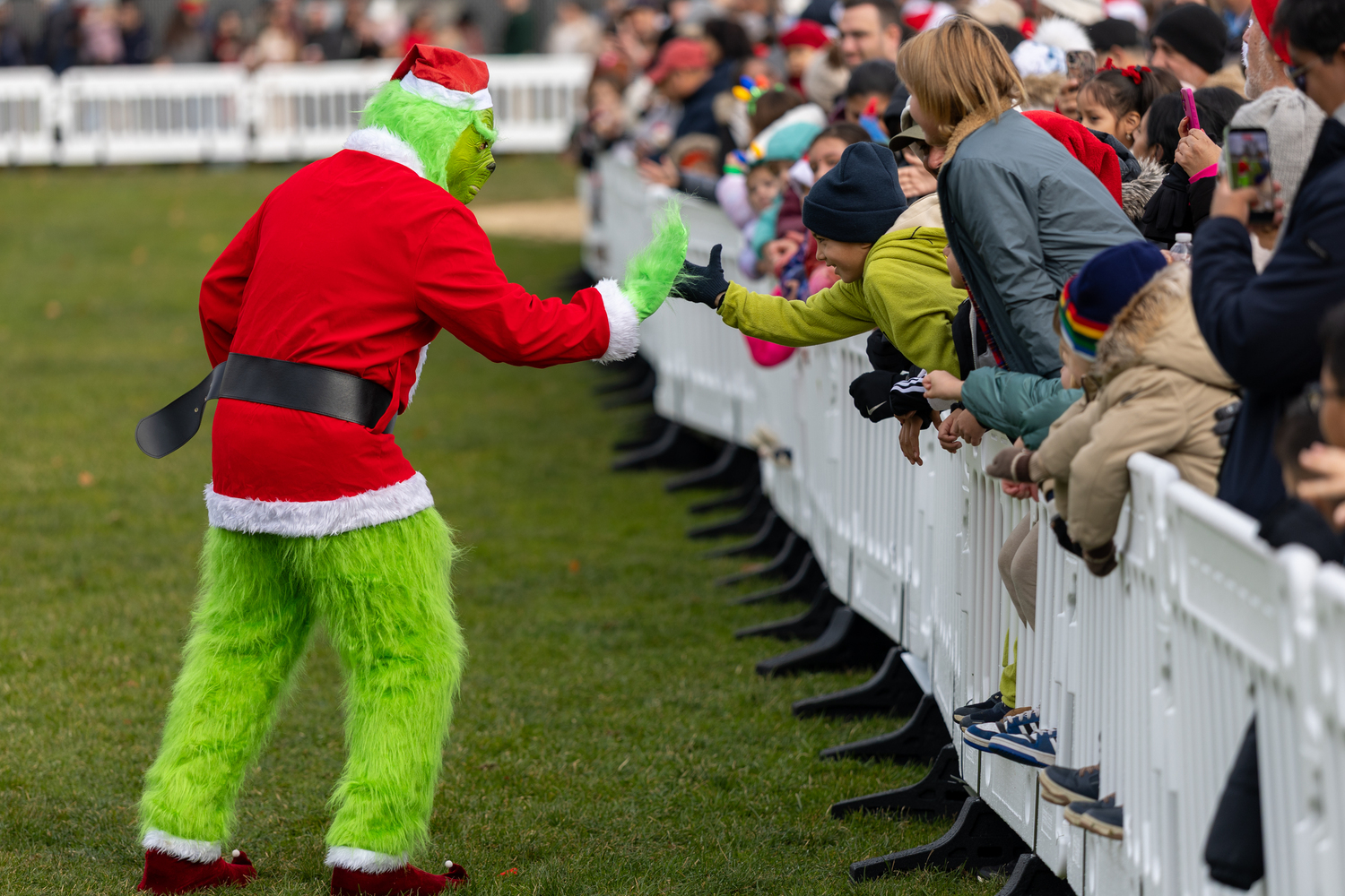 The Grinch greets spectators at Herrick Park on Saturday.  RON ESPOSITO