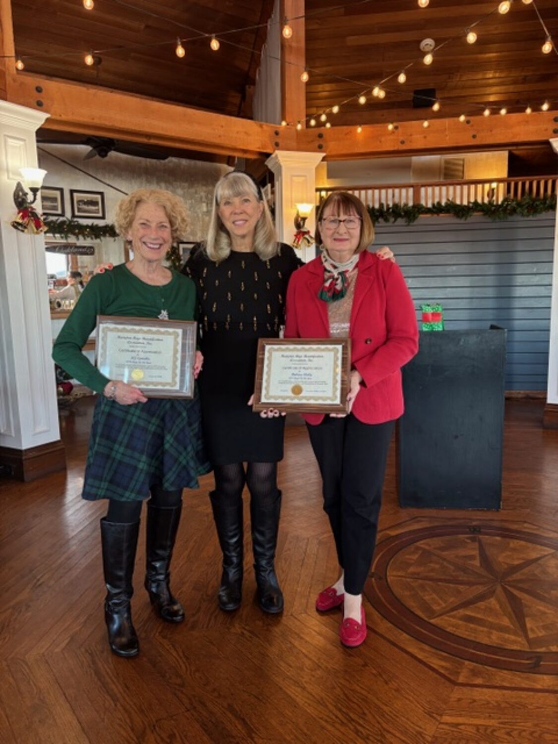 The Hampton Bays Beautification Association named MJ Spinella, left, and Barbara Skelly, right, its 2025 Angels of the Year. Susan von Freddi, the group's president, made the presentation.  COURTESY HAMPTON BAYS BEAUTIFICATION ASSOCIATION
