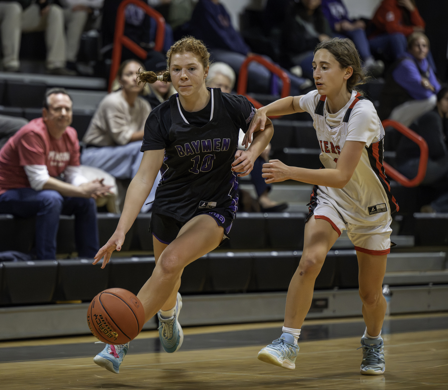 Hampton Bays freshman Fiona Haddock dribbles past Pierson sophomore Molly Wolfson.  MARIANNE BARNETT