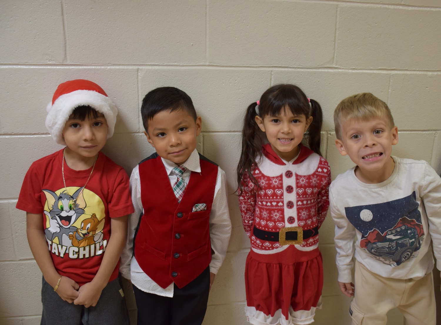 Hampton Bays Elementary School first grade students celebrated the holiday season with their annual “Holidays Around the World,” a festive annual production staged for family and friends. Dressed in colorful holiday outfits, each first grade class stood to recite facts and poems about the various holidays they had studied in class. They also entertained the audience by singing holiday songs. COURTESY HAMPTON BAYS SCHOOL DISTRICT